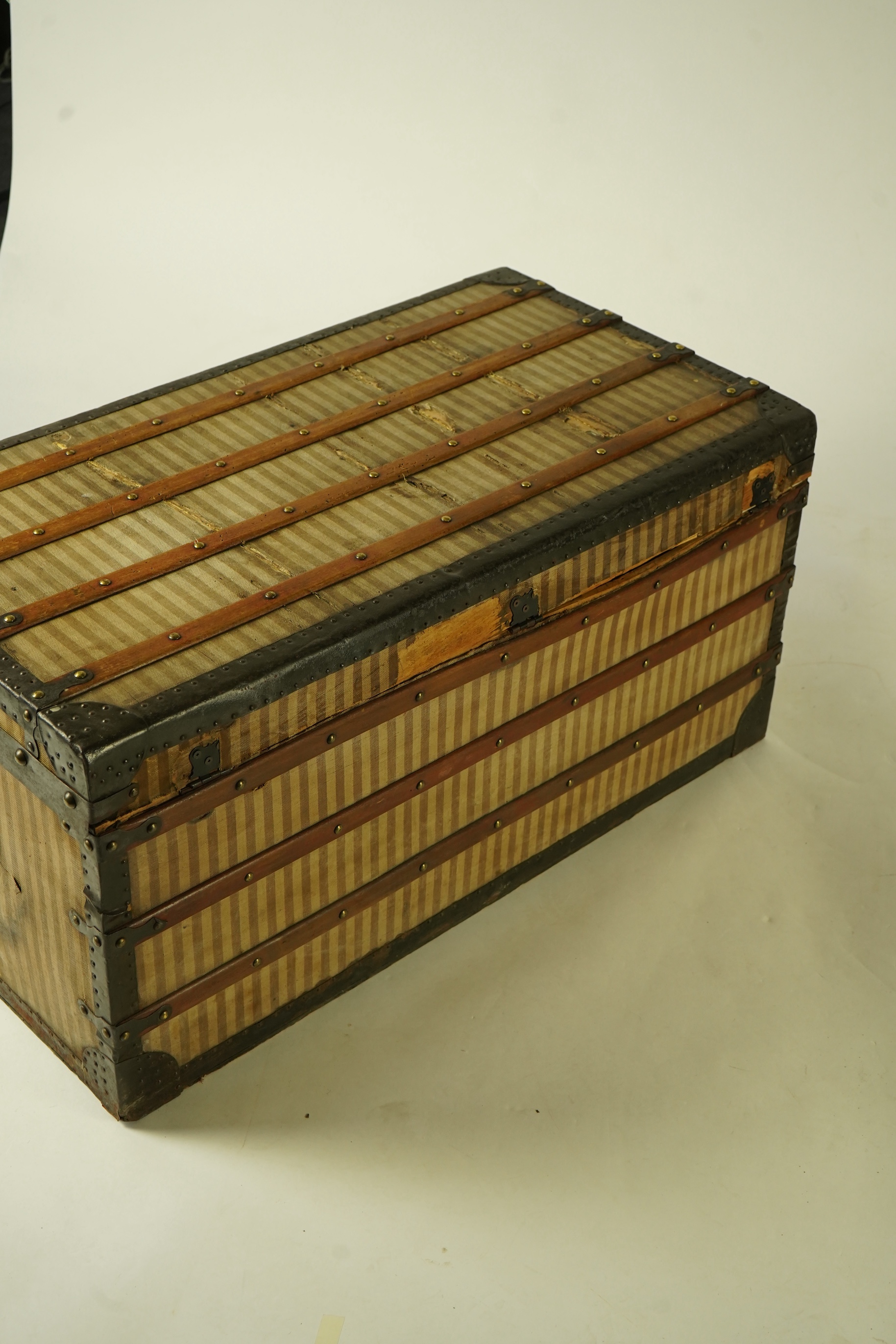 A vintage Louis Vuitton trunk with paper label to the interior numbered 142678, height 43cm, width 90cm, depth 48cm